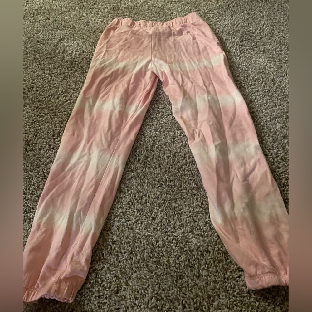 Pink sweatpants with white lines on it